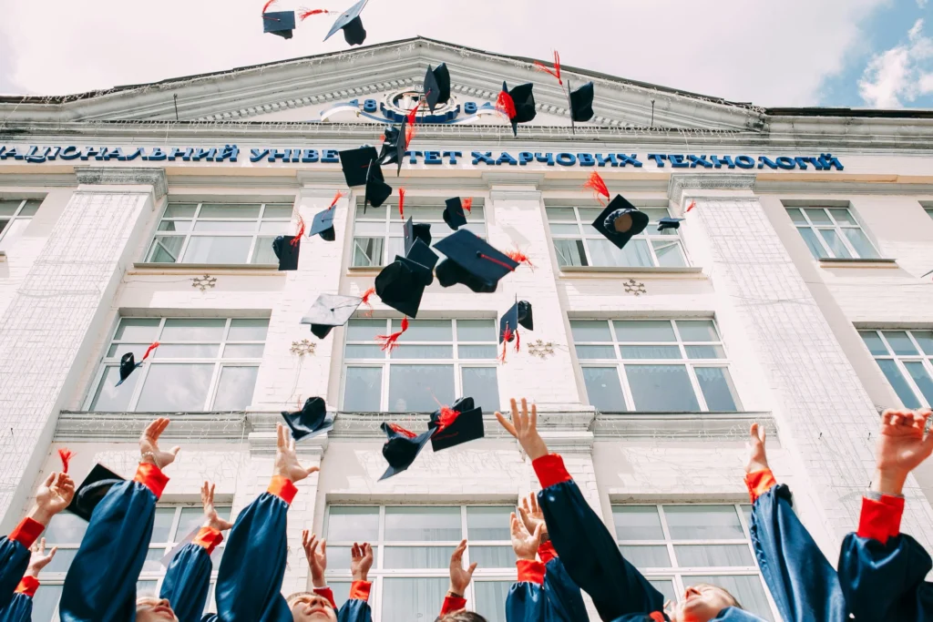 Students graduating and throwing their hats in the air.